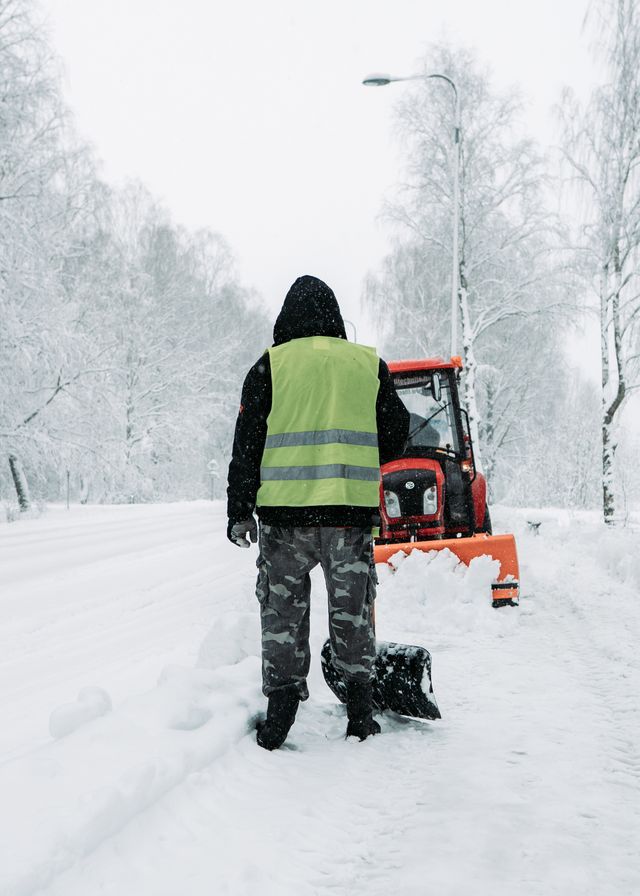 Snow plow operator clearing a residential road